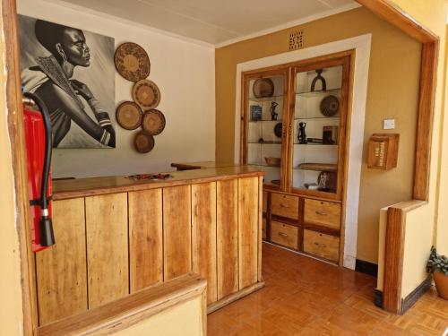 a room with wooden cabinets and plates on the wall at Africa Safari Arusha in Arusha
