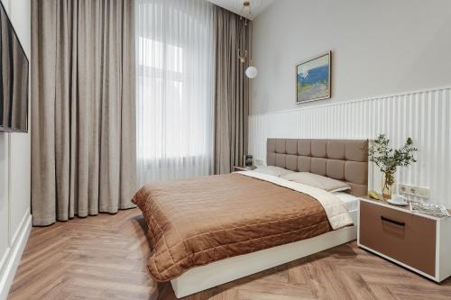 a bedroom with a bed and a large window at NEW! Luxury apartment in the CENTER of ODESSA overlooking Deribasovskaya str. LOW PRICE! in Odesa