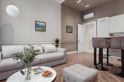 a living room with a couch and a table at NEW! Luxury apartment in the CENTER of ODESSA overlooking Deribasovskaya str. LOW PRICE! in Odesa