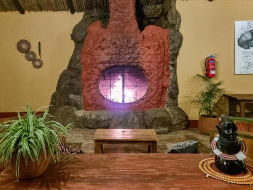 a room with a stone oven with a table at Africa Safari Arusha in Arusha