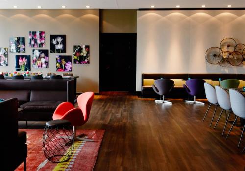a living room filled with furniture and a fire place at Motel One Amsterdam in Amsterdam