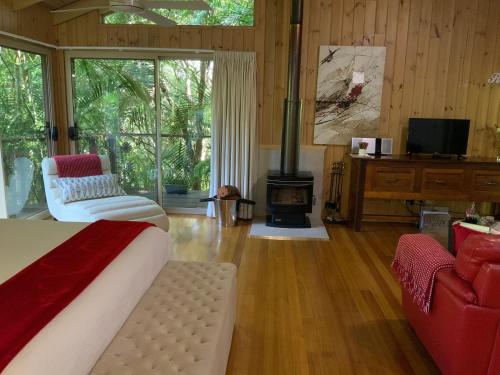 a living room with a bed and a fireplace at Belle's at Montville in Montville