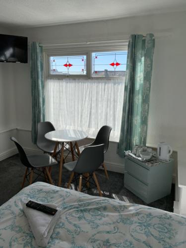 a hotel room with a bed and a table and chairs at The Danescourt in Blackpool