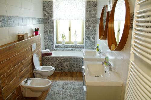 a bathroom with a toilet and a sink and a tub at Apartmány u komína in Terezín