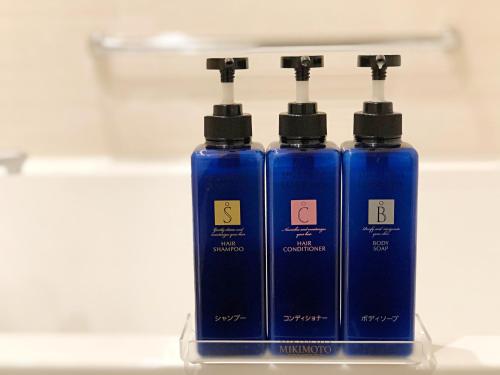 two blue bottles sitting on top of a counter at Royal Twin Hotel Kyoto Hachijoguchi in Kyoto