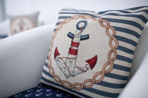 a cushion with an anchor painted on it at Atrani Apartments on the Amalfi Coast, air-purified, close to the beach and easy access in Atrani