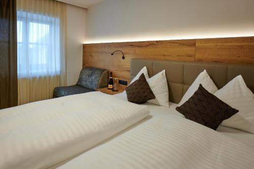 A bed or beds in a room at Landgasthof Mayr
