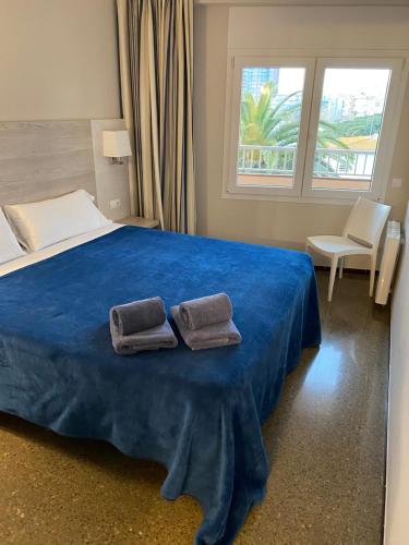 a bedroom with a bed with two towels on it at Apartaments la Catifa now with ELEVATOR!!! in Palamós