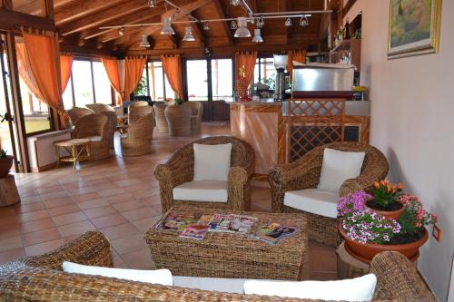 a living room with wicker chairs and a table at Residence New Paradise in Tropea