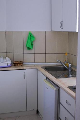 a kitchen with a sink and a counter top at Villa Alba Apartments in Dobra Voda