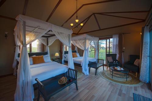 塞倫蓋蒂國家公園的住宿－Serengeti Sametu Camp，一间带两张床的卧室和一间客厅
