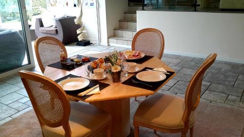 a dining room table with chairs and a table with food on it at B&B prince d’Orange Waterloo in Waterloo