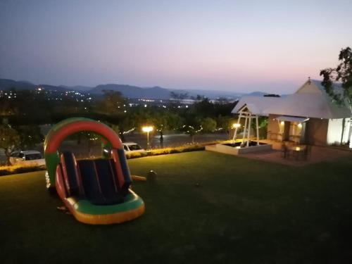 a playground with a slide in the grass at Villa Paradiso in Hartbeespoort