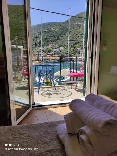 a room with a sliding glass door with a view of a patio at Fabulous apt. w/breakfast near the sea! in Sivota