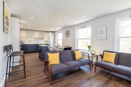 a living room with two couches and a kitchen at The Old Hotel Luxury apartments in York