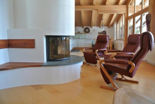 a living room with chairs and a fireplace at Appartement Seespitzhof in Scheffau am Wilden Kaiser
