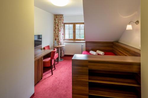 a hotel room with a bed and a desk at Leśne Patio in Katowice