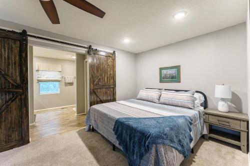 a bedroom with a bed and a sliding barn door at Smoky Blue in Gatlinburg