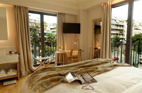 a bedroom with a large bed and a large window at Niche Hotel Athens in Athens