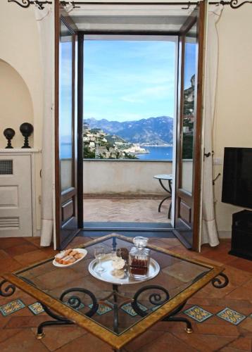 a living room with a view of the ocean at Villa Alba d'Oro - Historic luxury villa in Amalfi