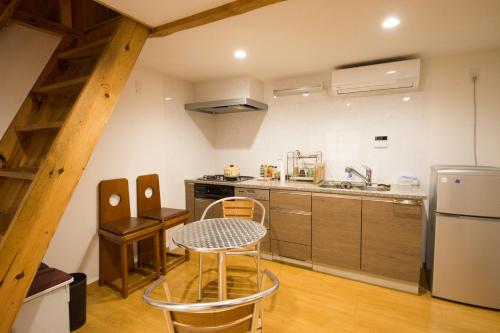 a kitchen with a table and chairs in a room at Roku in Kyoto