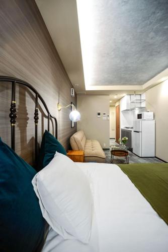 a bedroom with a bed and a living room at Ken's Place Azabudai in Tokyo