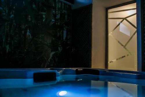 a glass table in front of a window at night at Hotel Nomada in Pozoblanco