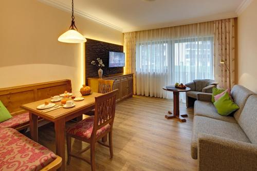 a living room with a couch and a table at Appartementhaus Absmeier in Bad Füssing