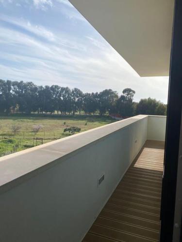 a balcony with a window with a view of a field at Archeo Hotel in Gela