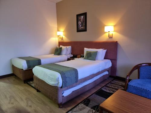 Hotel Nirvana by Luxury International tesisinde bir odada yatak veya yataklar