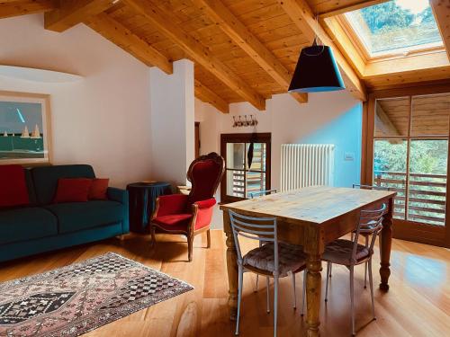 a living room with a wooden table and chairs at La Casa al Torrente in Riva del Garda