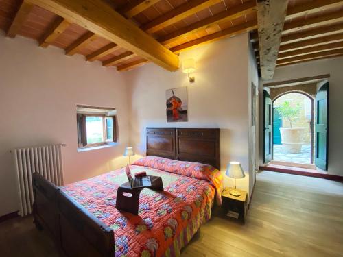 a bedroom with a large bed and a large window at Campora House in Tavarnelle in Val di Pesa