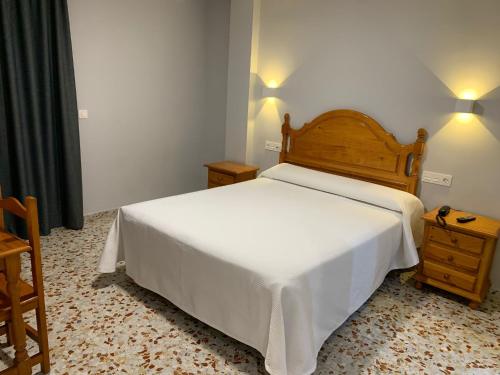 a bedroom with a bed and a dresser at Hotel Estrella Del Mar in Motril