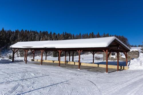 a snow covered pavilion with a snow covered roof at CHATA MISTRIK in Donovaly