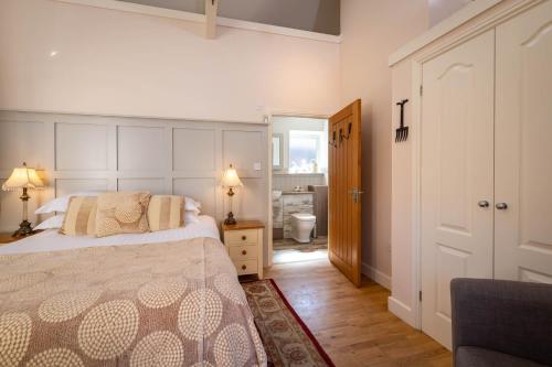 a bedroom with a bed and a hallway with a bathroom at The Lodge in Hunstanton