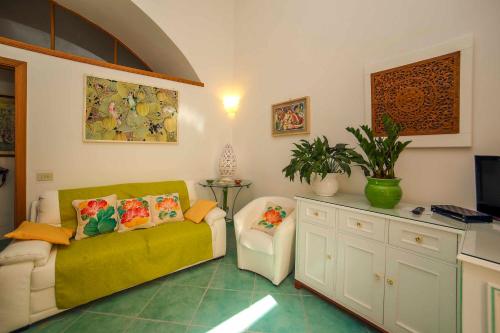 a living room with a couch and a tv at Atrani Apartments on the Amalfi Coast, air-purified, close to the beach and easy access in Atrani