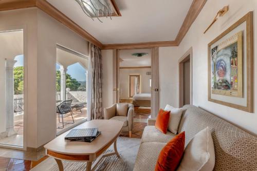 a living room with a couch and a table at Airelles Château de la Messardière in Saint-Tropez