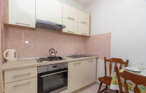 a kitchen with a sink and a stove at House Green Side Sunset in Prigradica