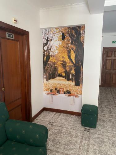a living room with a painting on the wall at Alojamento das Caldas in Caldas de Aregos
