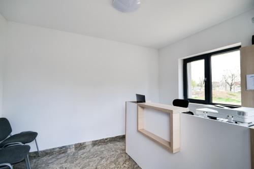 an office with a reception desk and a window at Hotel Ema&Zain in Bucharest