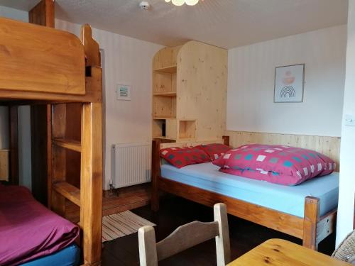a bedroom with two bunk beds and a table at Aille River Tourist Hostel and Camping Doolin in Doolin