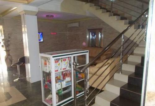 a refrigerator in a room with a staircase at Dublina Hotels - Superior in Asaba