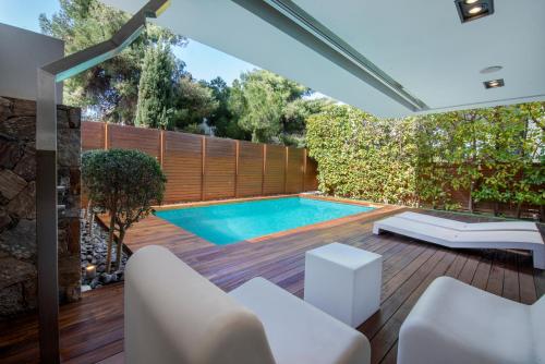 a swimming pool in the backyard of a house at Elegant and Private Living by Neuvel in Athens