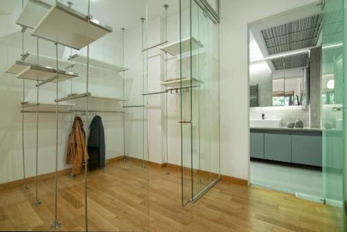 a glass room with a sink and a bathroom at Elegant and Private Living by Neuvel in Athens