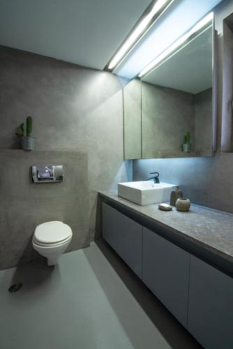 a bathroom with a white toilet and a sink at Elegant and Private Living by Neuvel in Athens