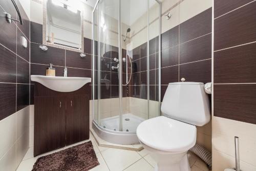 a bathroom with a toilet and a sink and a shower at Penzion U Hráze in Luhačovice