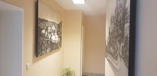a hallway with two pictures on the walls at Zum Fuchsbau in Niederhövels