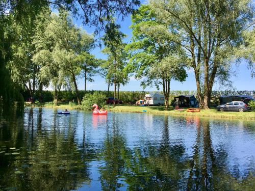 a family kayaking on the river at a campsite at Glamping Betuwe in Kesteren