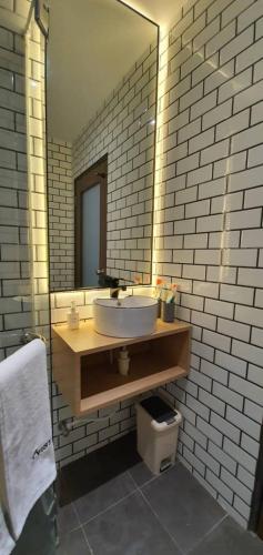 a bathroom with a sink and a mirror at VISTA HOTEL in Tawau