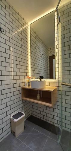a bathroom with a sink and a mirror and a toilet at VISTA HOTEL in Tawau